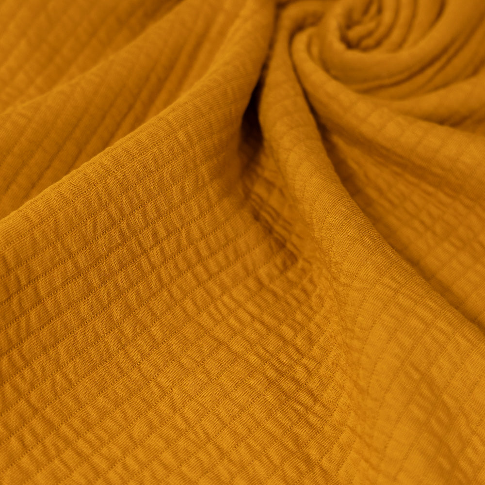 Coupon 150cm quilted jersey oker